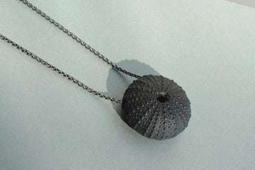 necklace of a black sea urchin made out of porcelain